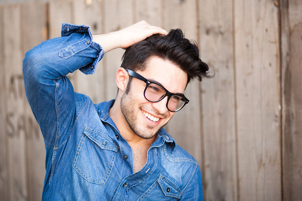 handsome young man smiling outdoors